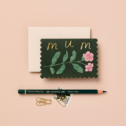 Deep green mini card with a pink wildflower illustration, reading mum in gold script