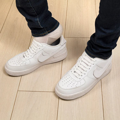 White no-tie shoe band installed on a laced sneaker.