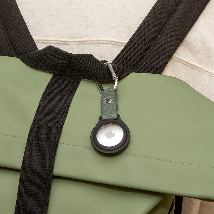 Tracker travel clip shown attached to a bag strap.