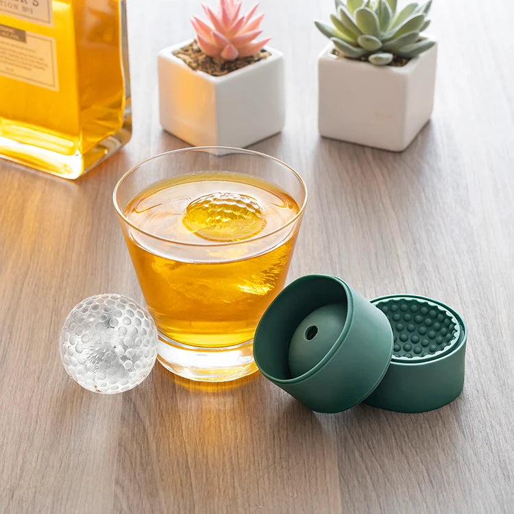 Golf ball ice mold shown closed in stacked green silicone halves.