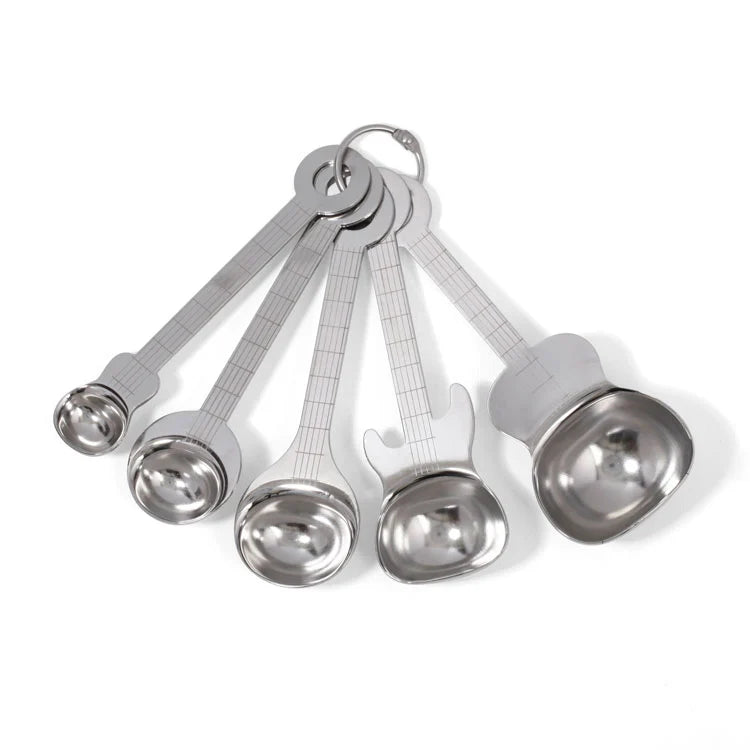 Set of five stainless steel measuring spoons shaped like guitars, fanned out and connected by a metal ring.