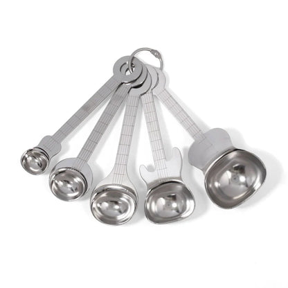 Set of five stainless steel measuring spoons shaped like guitars, fanned out and connected by a metal ring.