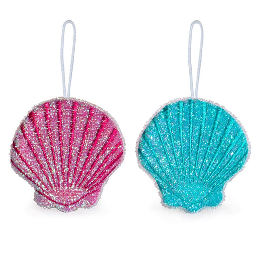 Set of two glittery seashell-shaped scrub sponges in pink and teal with a hanging loop, shown against a white background.