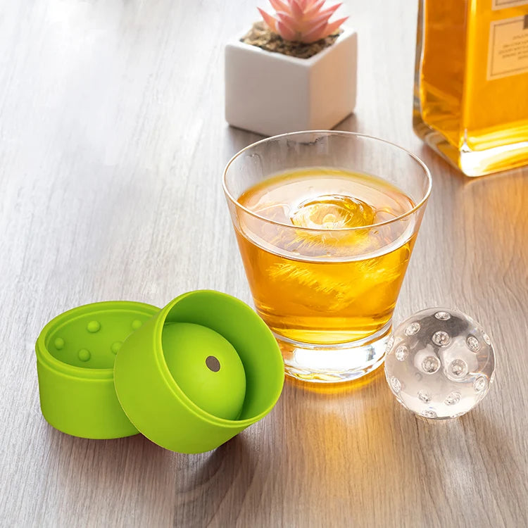 Pickleball ice ball mold shown closed in stacked green silicone halves.