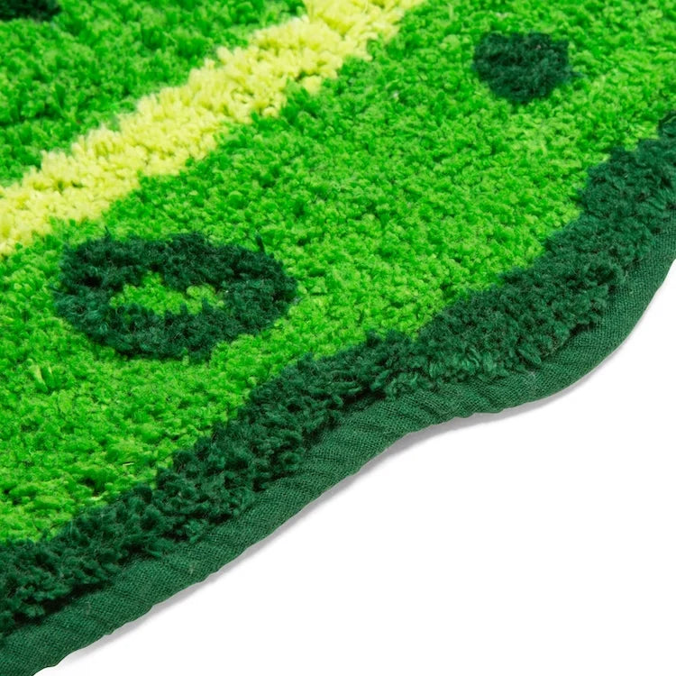 Pickle bath mat shown on a bathroom floor.