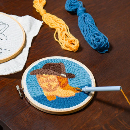 Western punch needle kit contents including acrylic yarn and bamboo hoop.
