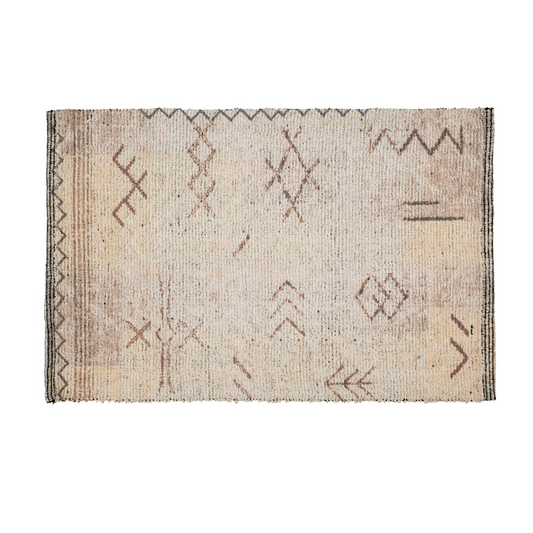 Cream cotton rug with rust and brown tribal-inspired geometric line patterns and a striped border
