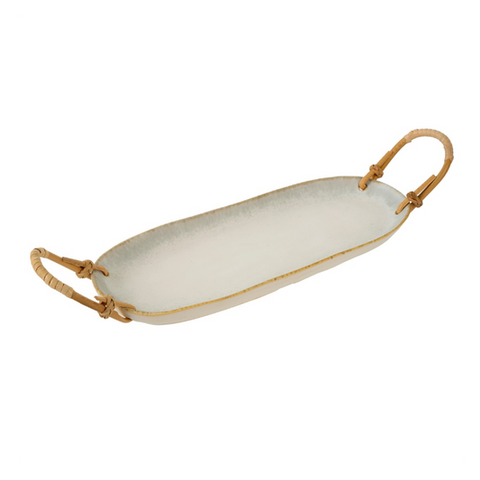 Oval white ceramic platter with a stone-washed glaze and wrapped rattan handles on each end