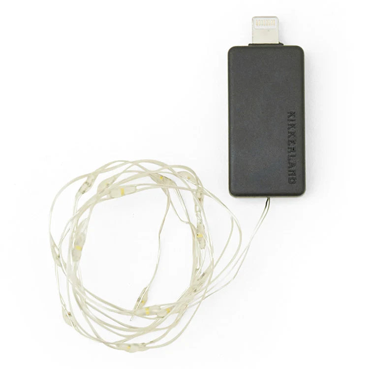 Sound activated string light shown lit up in a dark room.