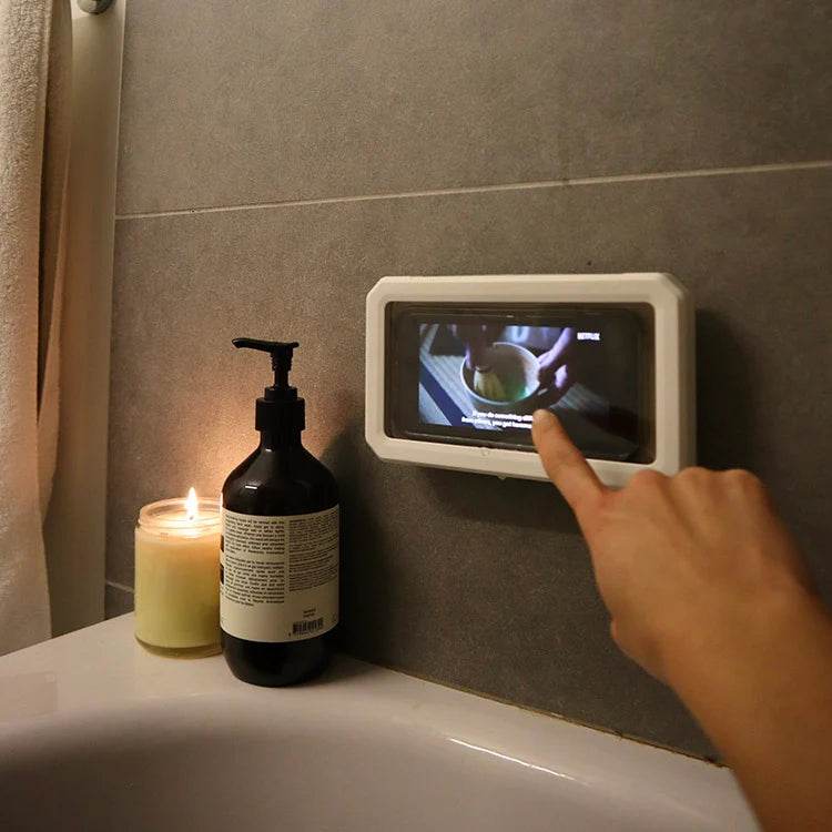 Shower proof phone case mounted to tiled shower wall holding a smartphone.