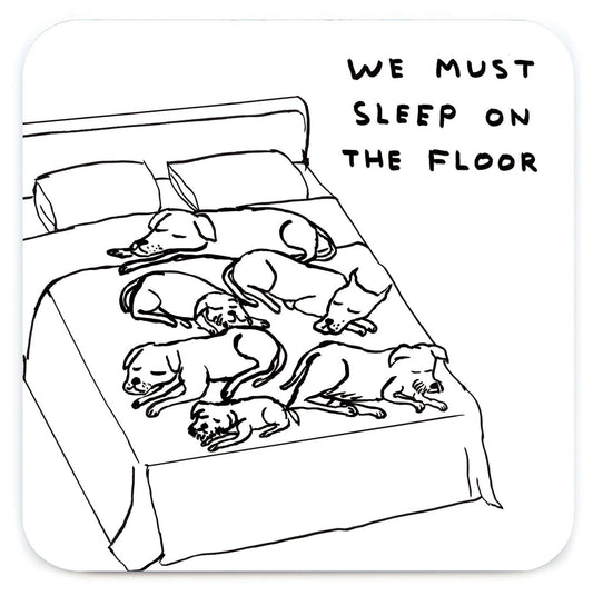 David Shrigley line drawing of dogs sprawled across a bed captioned "We must sleep on the floor," printed on a coaster - PABOOM