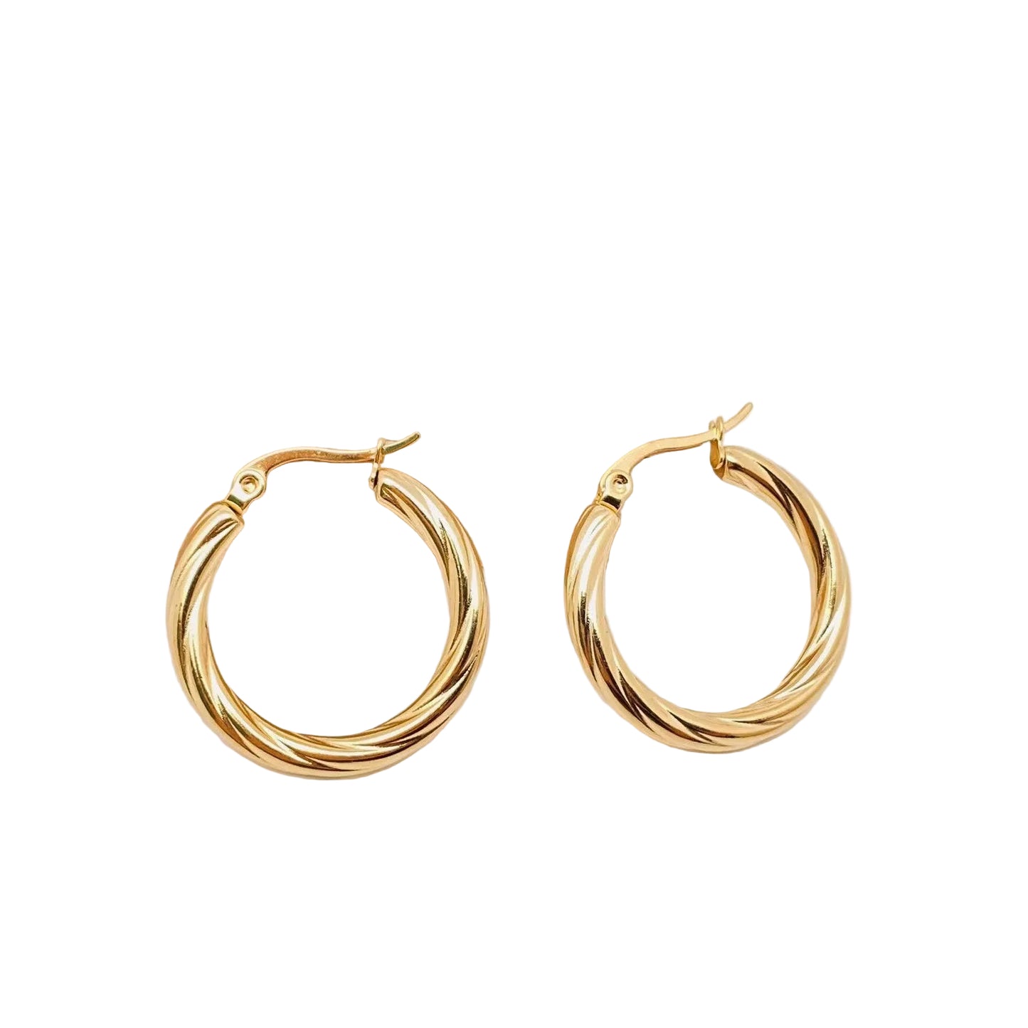 Gold hoop earrings on a light wooden block with a white background