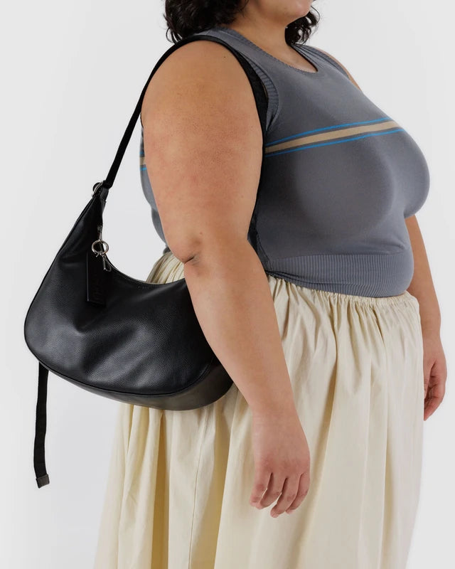 Close-up of the debossed keychain and key leash on the BAGGU Medium Recycled Leather Flat Crescent bag