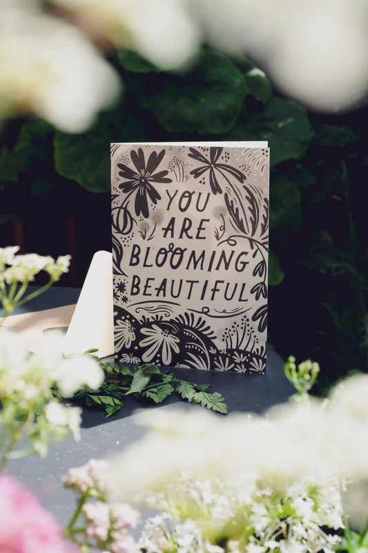 'You Are Blooming Beautiful' card with kraft envelope on a light background