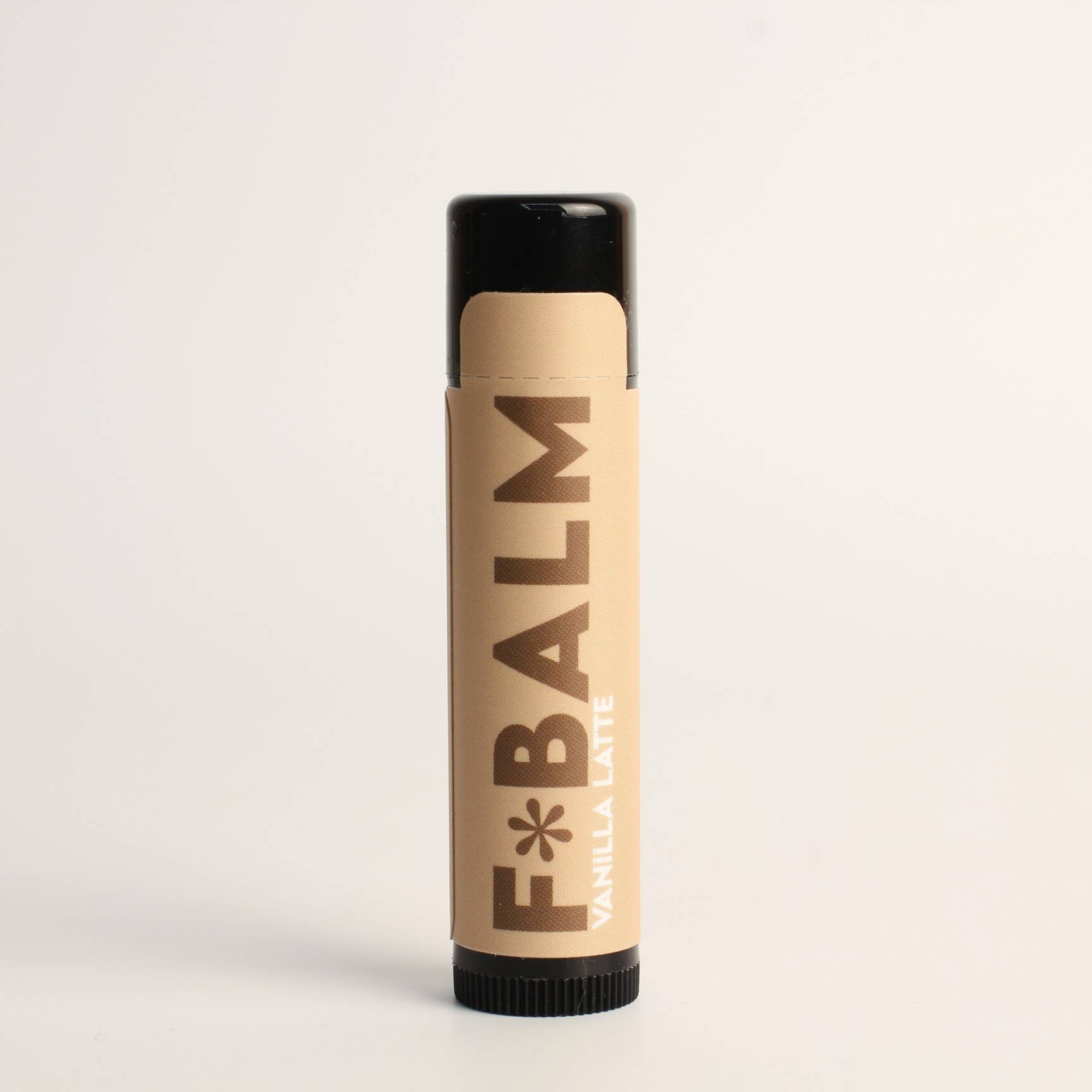 Charleston & Harlow F*Balm Vanilla Latte lip balm tube with tan kraft-paper label