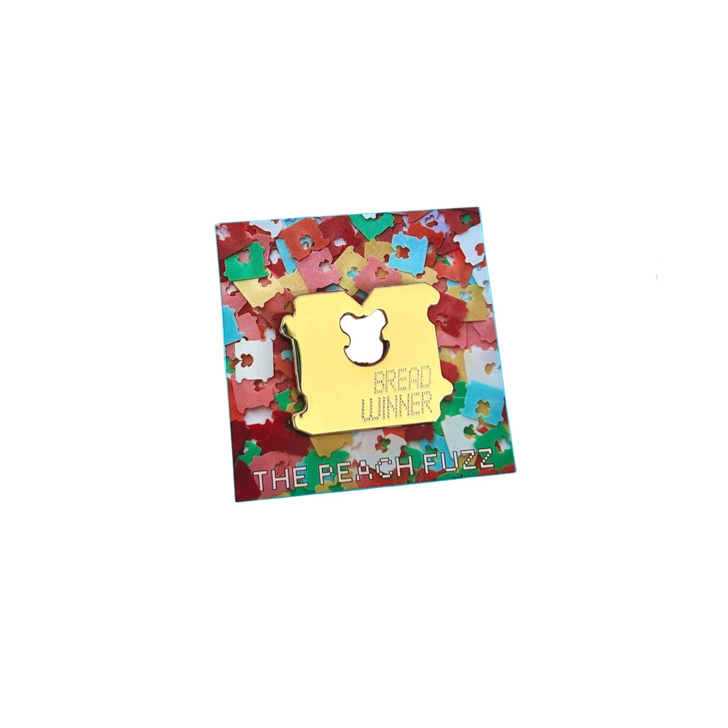 Gold enamel pin shaped like a slice of bread with a bear-shaped bite mark, reading Bread Winner, on a colorful confetti-print backing card