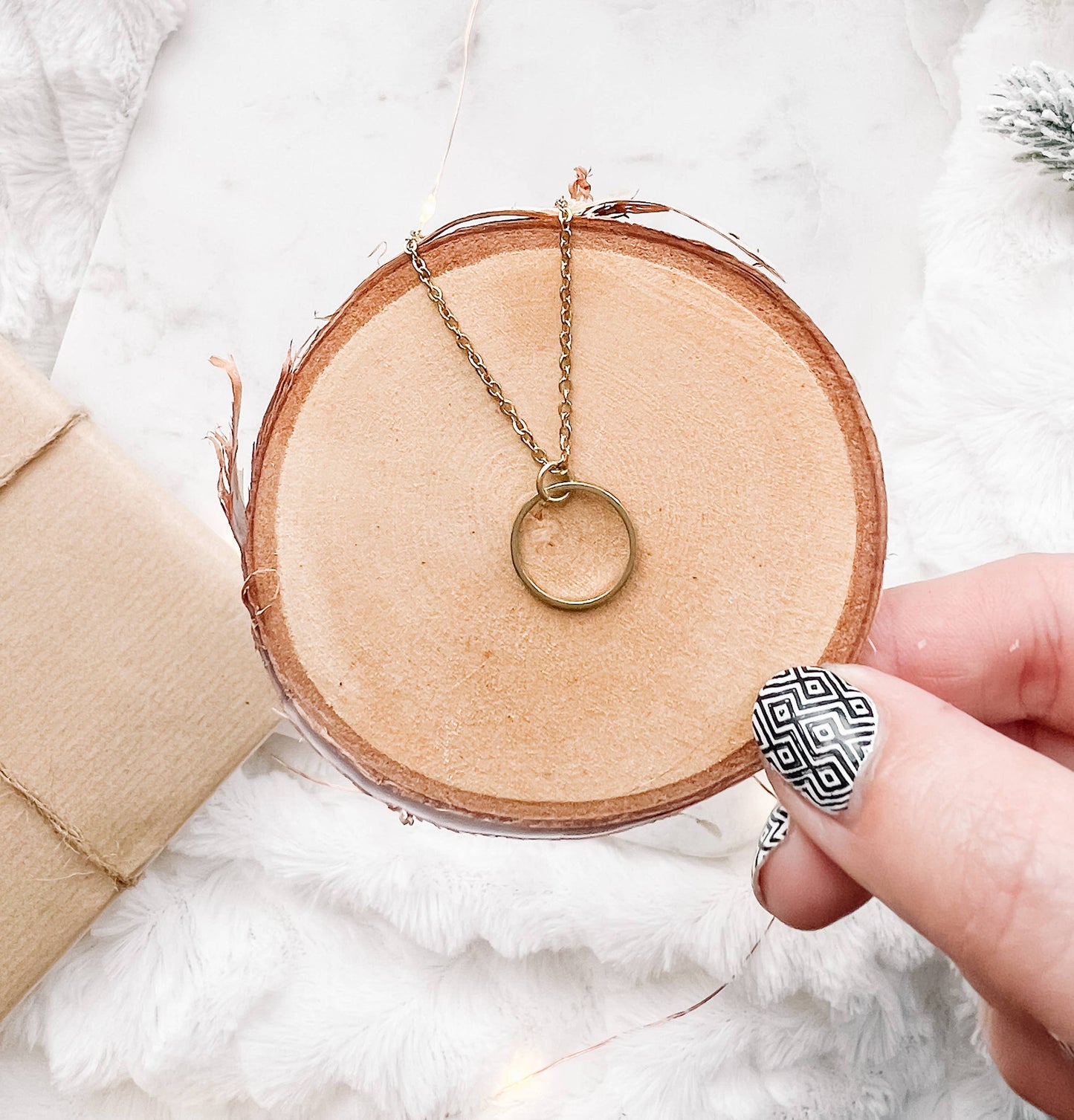 Close-up of raw brass circle pendant necklace chain detail