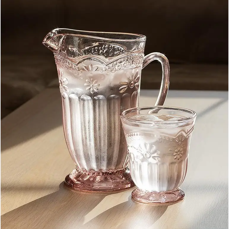 Retro pink glass pitcher and tumbler set on sunlit wooden table - PABOOM