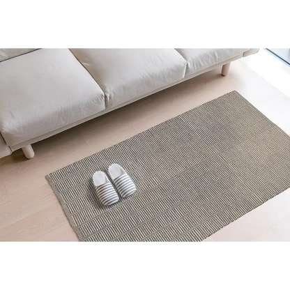 Multicolour broken stripe cotton mat styled in living room with couch and slippers – 36x60 inch - PABOOM