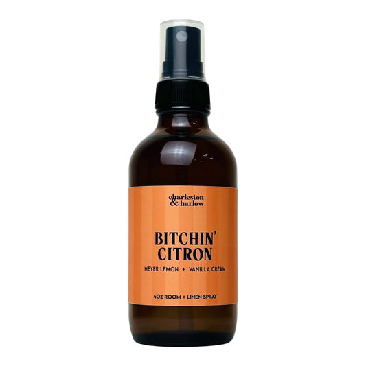 Amber glass spray bottle of Charleston & Harlow Bitchin' Citron room and linen spray with orange label