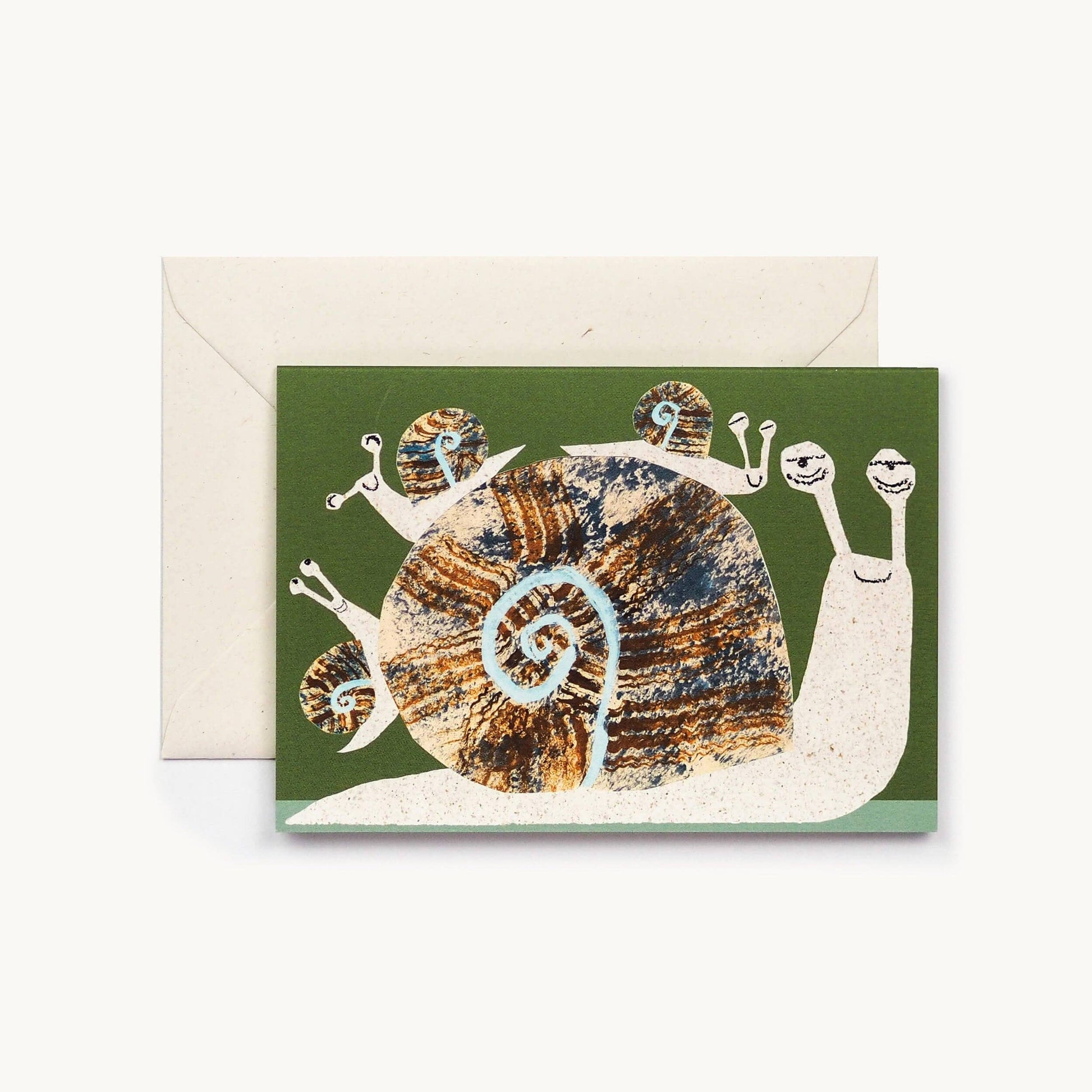 Olive green greeting card with an illustrated giant snail carrying four smaller baby snails on its shell, cream envelope behind