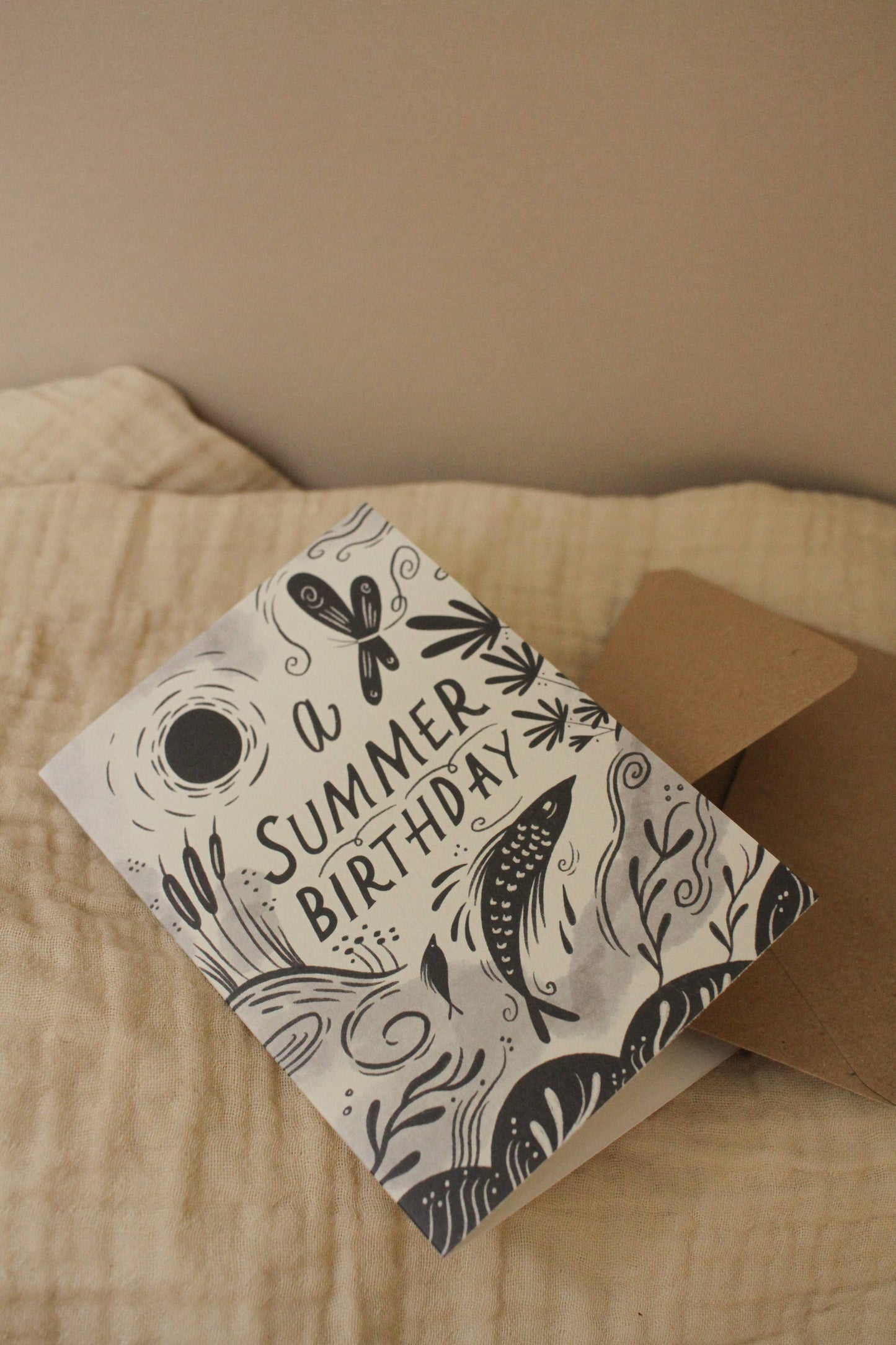 Close-up of the illustrated fish and botanical details on 'A Summer Birthday' card