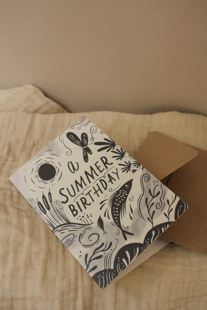 Close-up of the illustrated fish and botanical details on 'A Summer Birthday' card