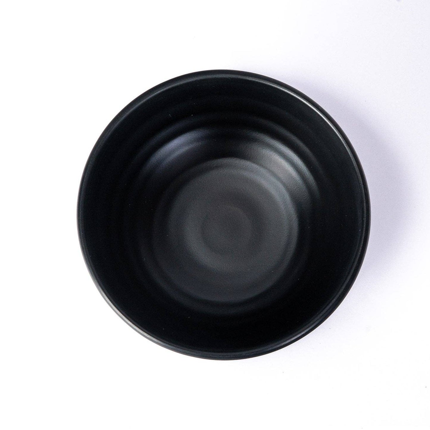 Matte black melamine bowl close-up of ribbed texture