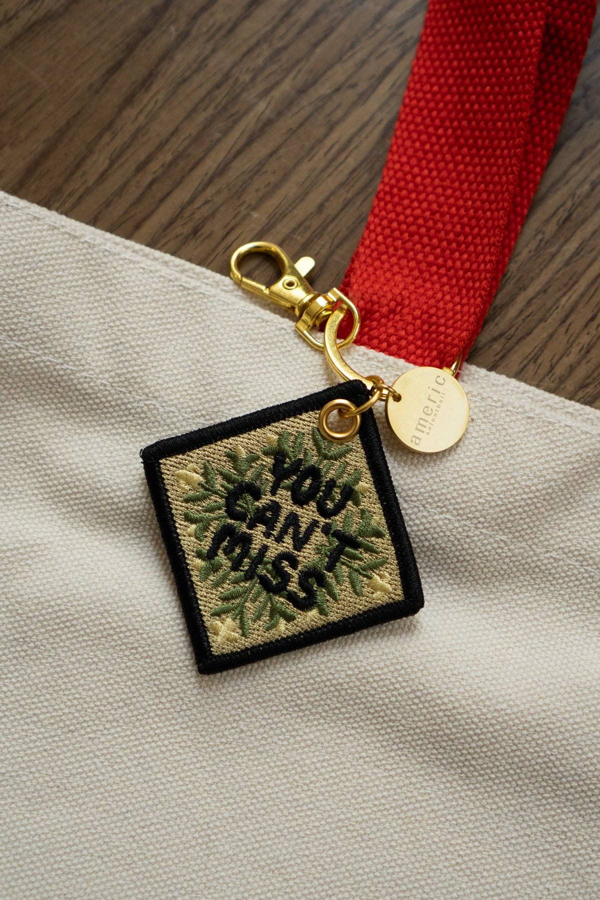 Never Meant Embroidered Keychain shown both sides