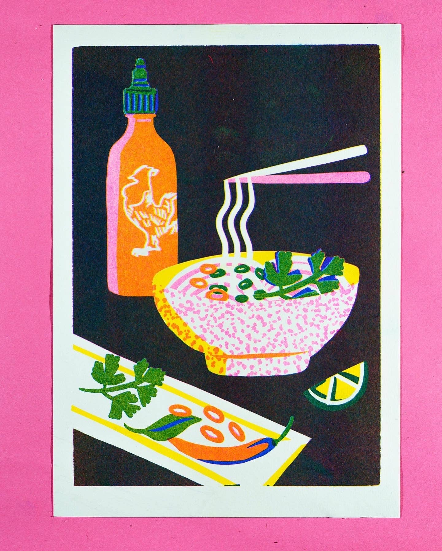 Risograph print of a steaming bowl of pho with chopsticks, sriracha and lime on a pink background - PABOOM