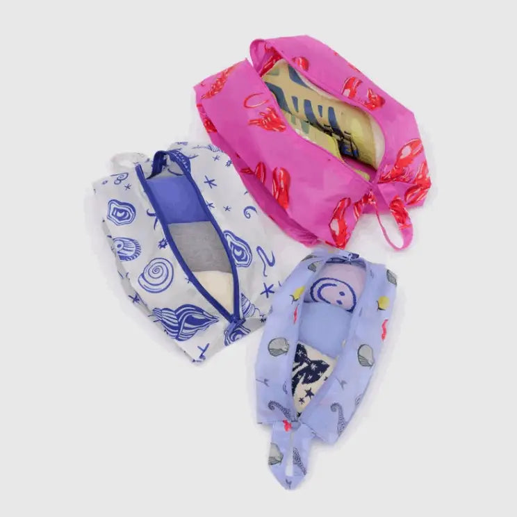 Open BAGGU 3D Zip Set Sea Creatures pouches showing interior space with travel items packed - PABOOM