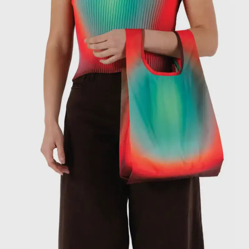 Baby Baggu featuring a gradient from red to turquoise being held on the arm - PABOOM