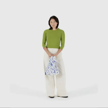 Baby Baggu bag featuring a mermaid pattern being held in the arm