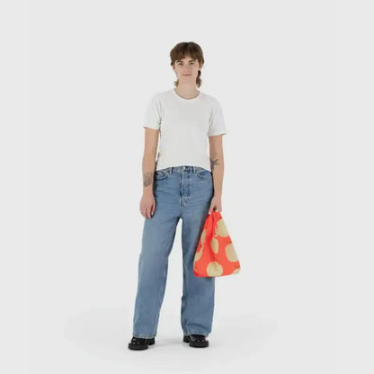 Baby Baggu bag featuring a melon pattern being held in the hand - PABOOM