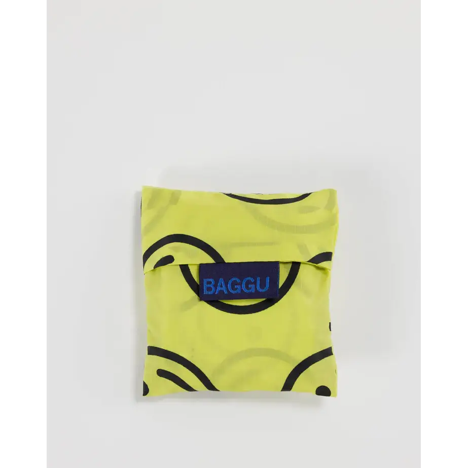 Baby Baggu bag with smiley face pattern being folded into a pouch - PABOOM