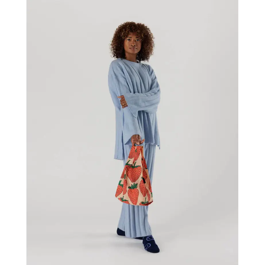 Baby Baggu bag featuring a strawberry pattern being held in the hand - PABOOM