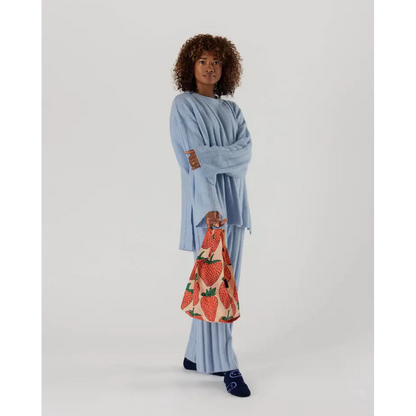 Baby Baggu bag featuring a strawberry pattern being held in the hand - PABOOM