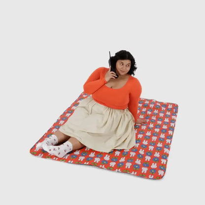 BAGGU Person sitting on Miffy Puffy Picnic Blanket with red bunny and flower design - PABOOM