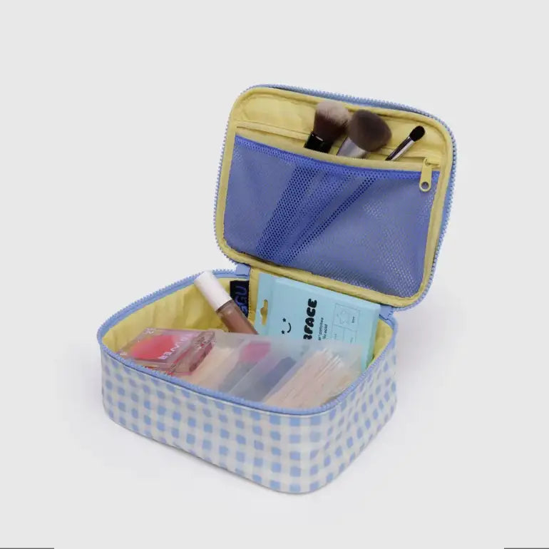 Open BAGGU small cosmetic bag in light blue gingham ripstop nylon, showing zipper closure and cosmetics inside – PABOOM