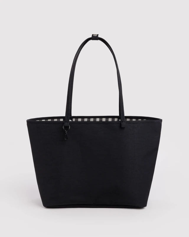 Black BAGGU Large Nylon Reversible Tote shown from the front, with black and white gingham trim peeking out along the top edge