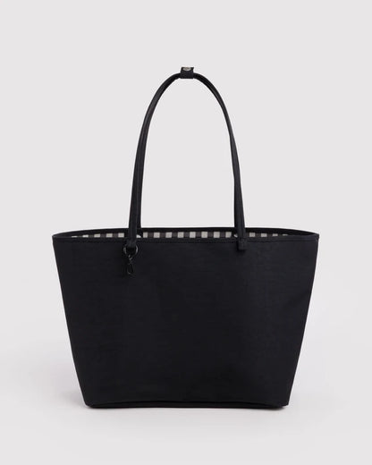 Black BAGGU Large Nylon Reversible Tote shown from the front, with black and white gingham trim peeking out along the top edge