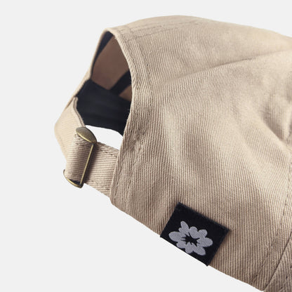 Side view of The Triplets tan dad hat showing adjustable metal clasp - PABOOM