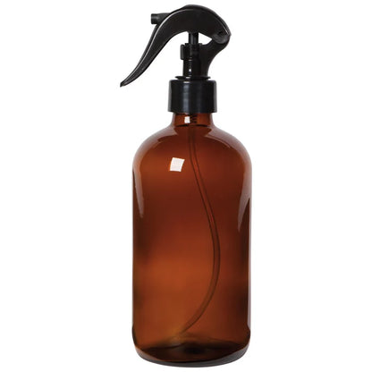 Amber glass spray bottle with a black trigger nozzle on a plain background – PABOOM