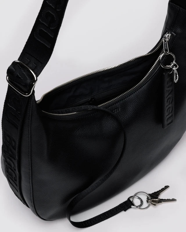 BAGGU Medium Recycled Leather Flat Crescent bag shown from the side to highlight its silhouette
