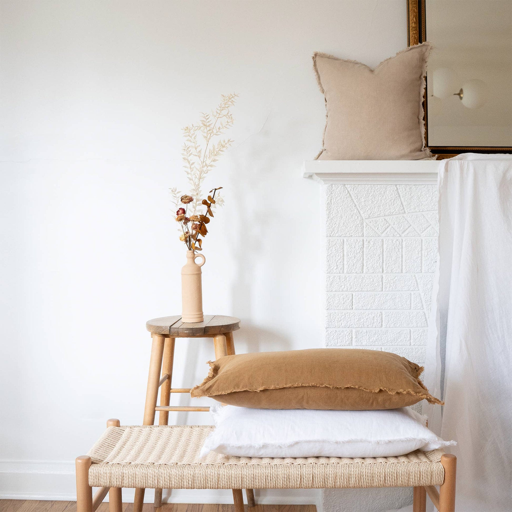 White fringed linen lumbar pillow cover styled on a sofa