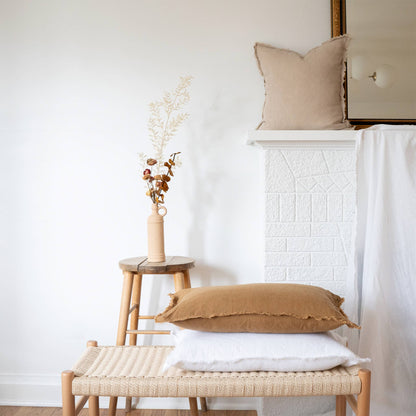 White fringed linen lumbar pillow cover styled on a sofa