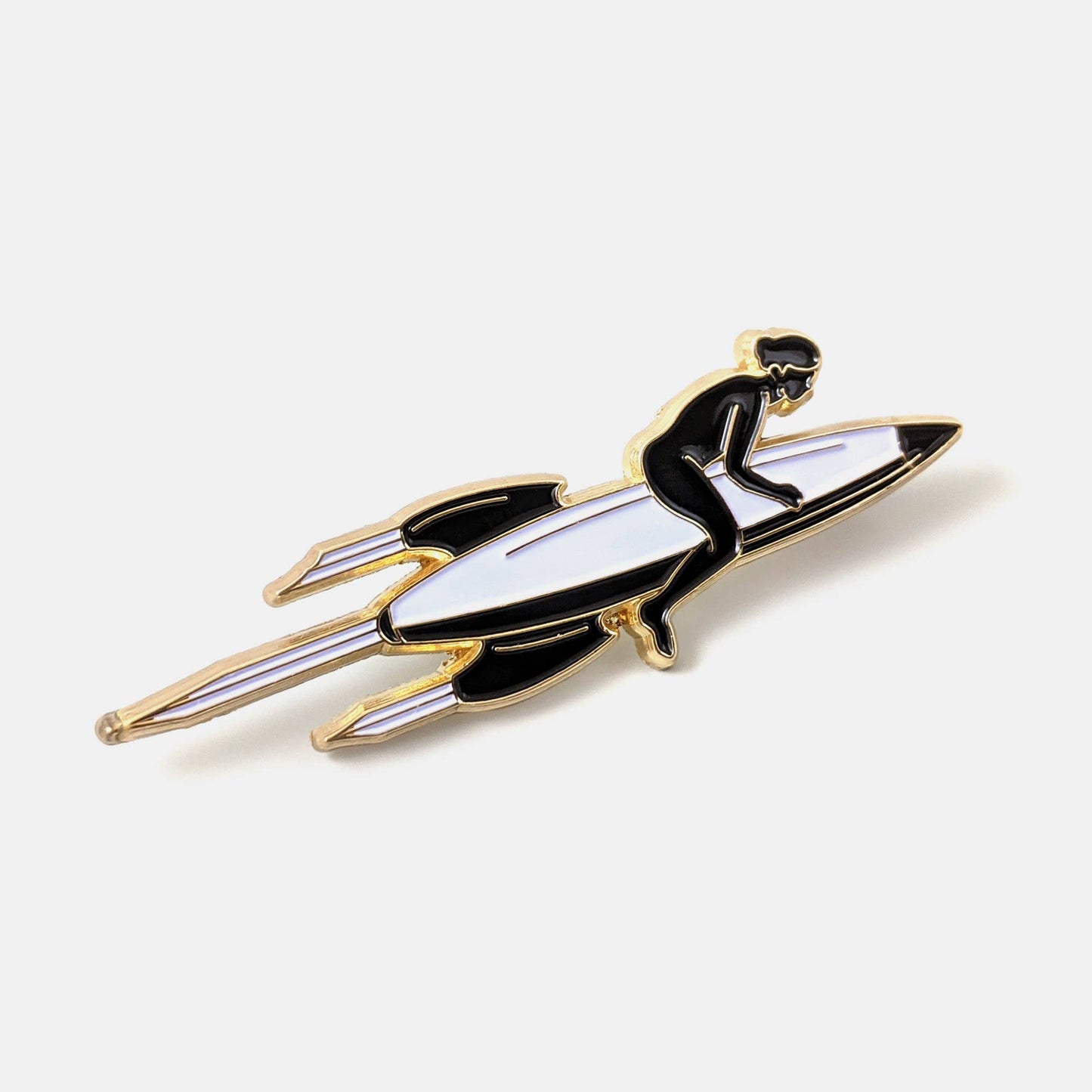 Gold and black enamel pin of a figure riding a rocket like a surfboard - PABOOM