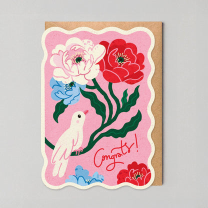 Scalloped pink congratulations card with an illustrated white dove among red and blush peonies and "Congrats!" in red script.