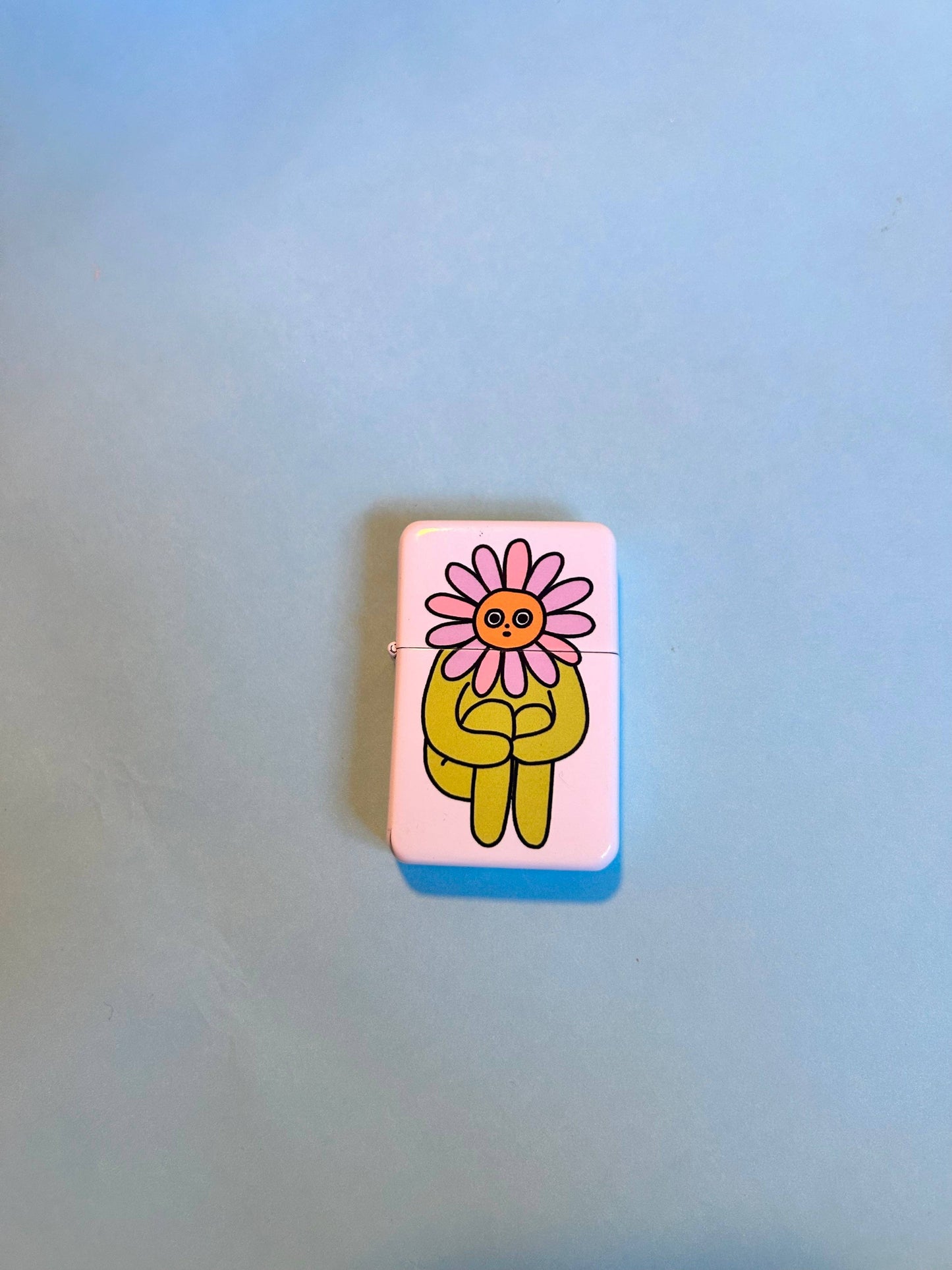 Flower Boy lighter styled in grass