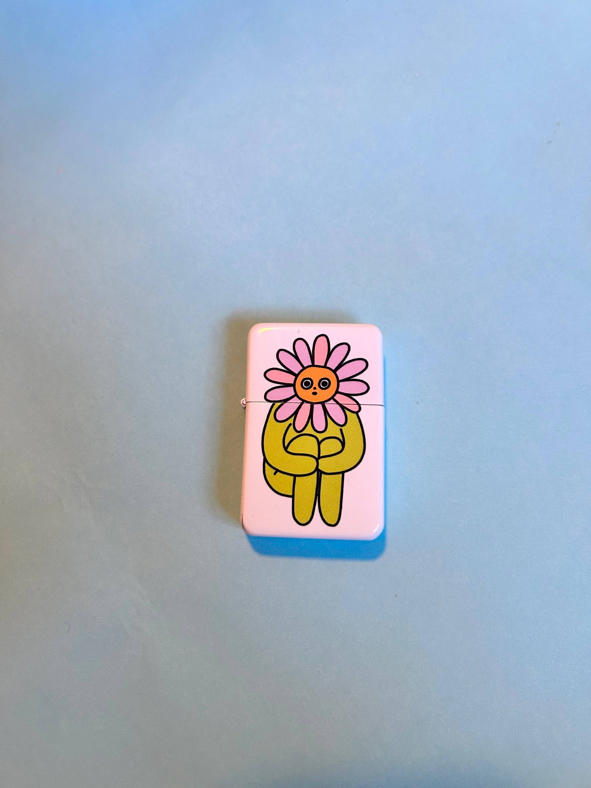 Flower Boy lighter styled in grass